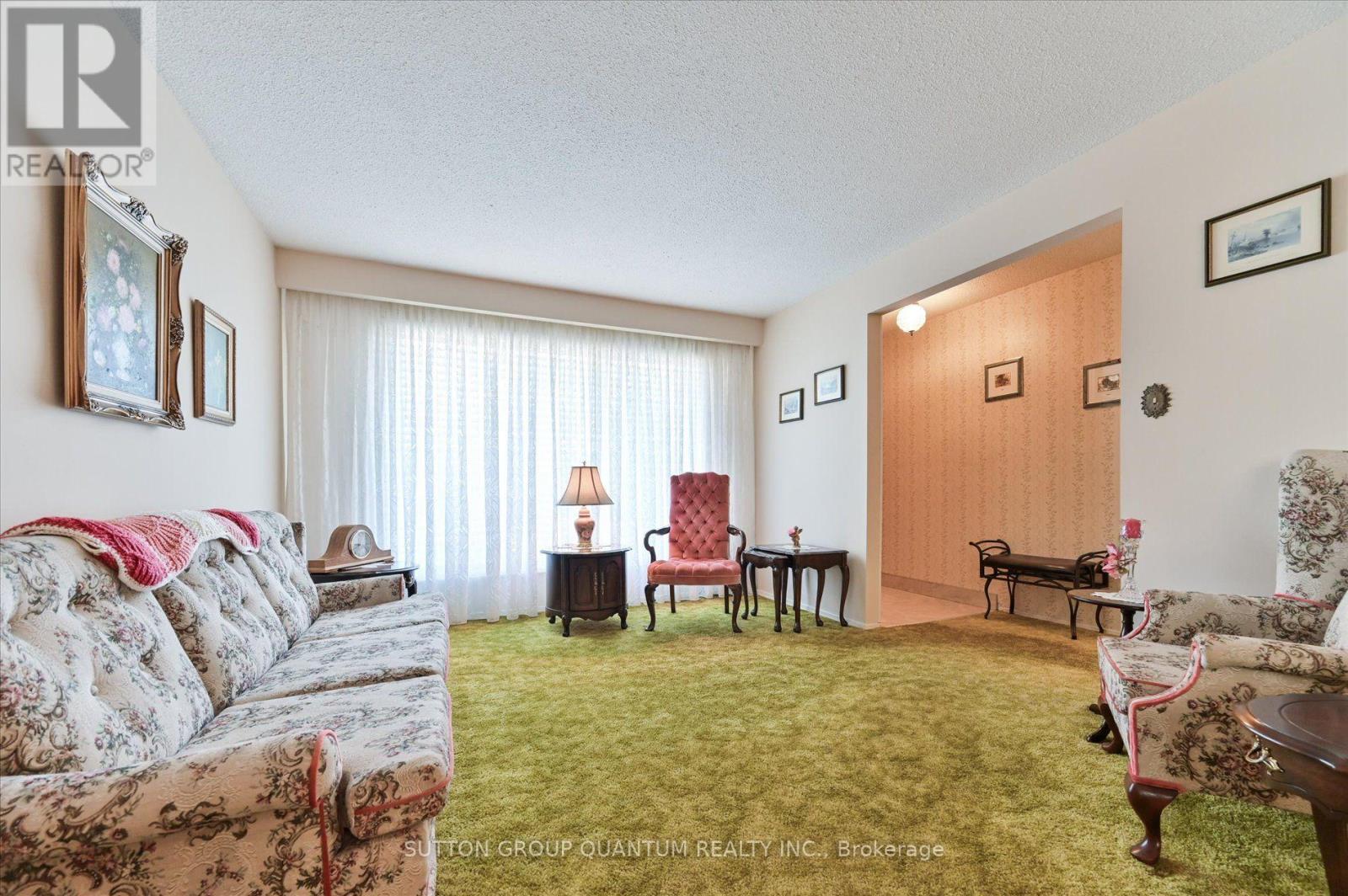 Living room toward the dining archway — 3661 Keenan Crescent